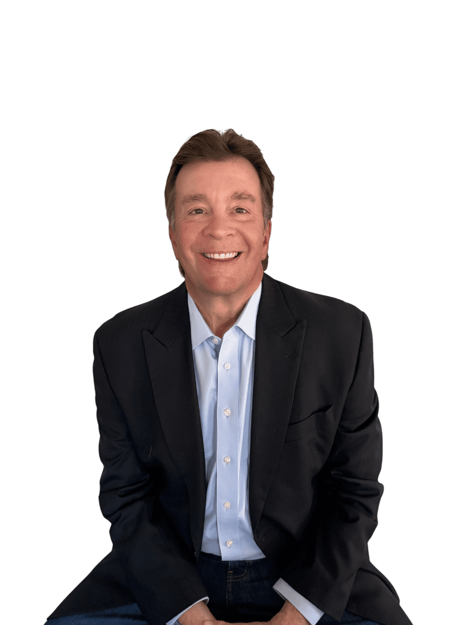 A man in a suit and tie smiling for the camera.